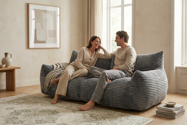 Couple installé sur le canapé pouf Pola Duo gris anthracite